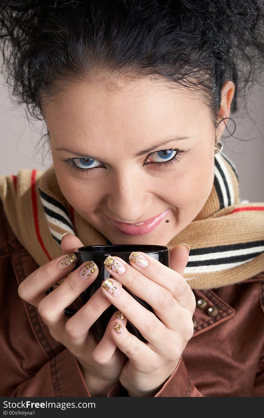 An image of a girl with blue ayes drinking tea