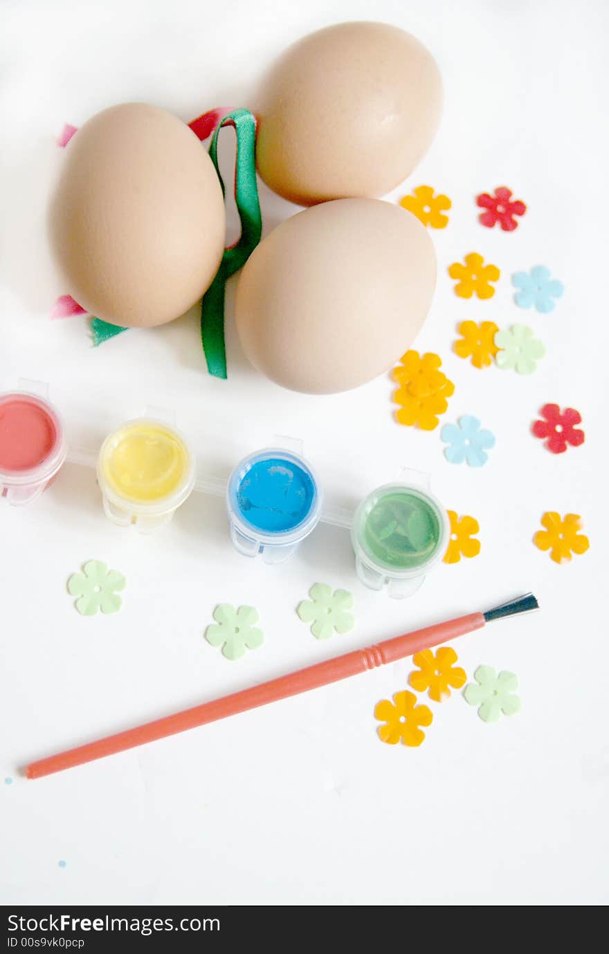 Eggs ready to be decorated with paint and ribbons for easter celebration. Eggs ready to be decorated with paint and ribbons for easter celebration