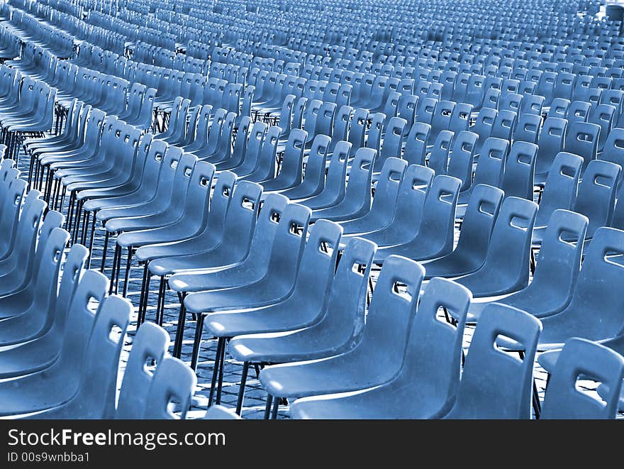 Rows of empty seats, lots of chairs. Rows of empty seats, lots of chairs