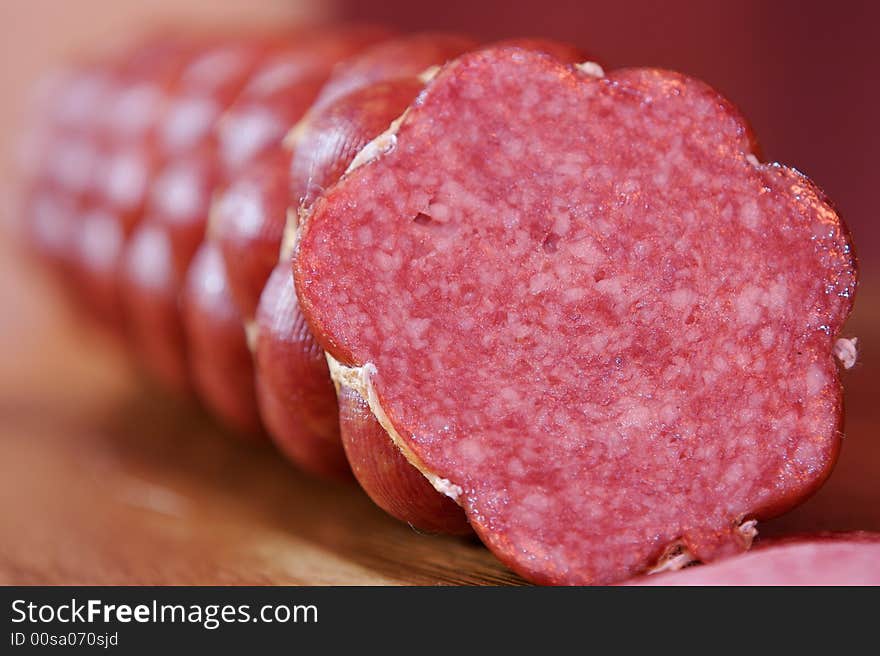 Slices of cooked smoked sausage isolated on white background