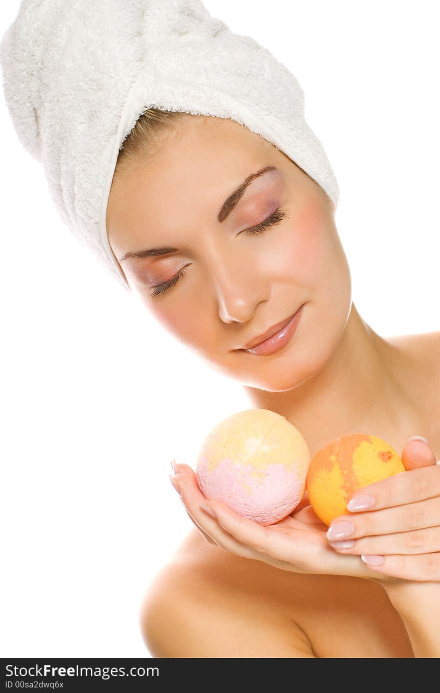 Beautiful young woman with aroma bath ball isolated on white background