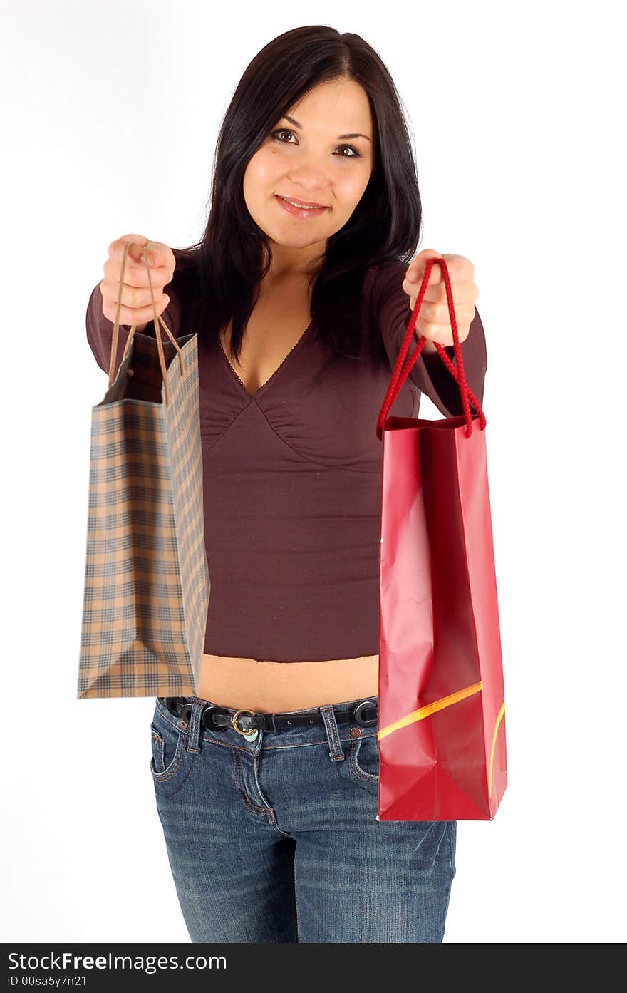 Attractive brunette woman with shopping bags on white background