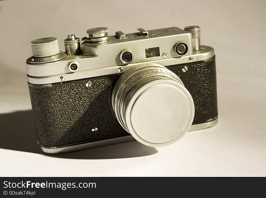 Sepia colored portrait of old-fashioned camera. Sepia colored portrait of old-fashioned camera