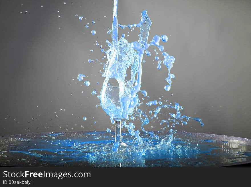 Splashing blue water on grey background. Splashing blue water on grey background