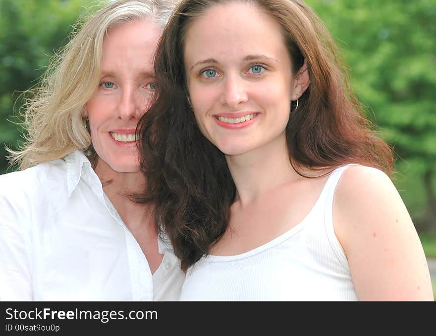 Portrait of a mother and daughter outdoors.