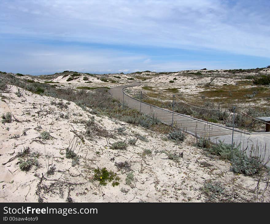 Walkway in the dunes towards the sky