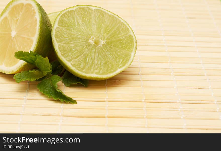 Closeup of three lemons on wooden placemat