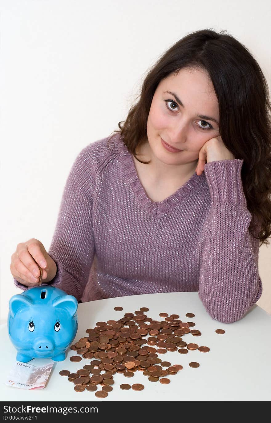 A young attractive woman with blue piggy-bank. A young attractive woman with blue piggy-bank