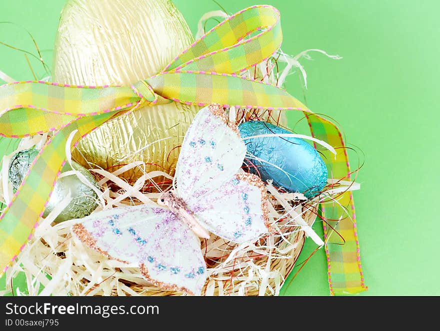 Assortment of chocolate Easter eggs wrapped in colorful paper with butterfly. Assortment of chocolate Easter eggs wrapped in colorful paper with butterfly