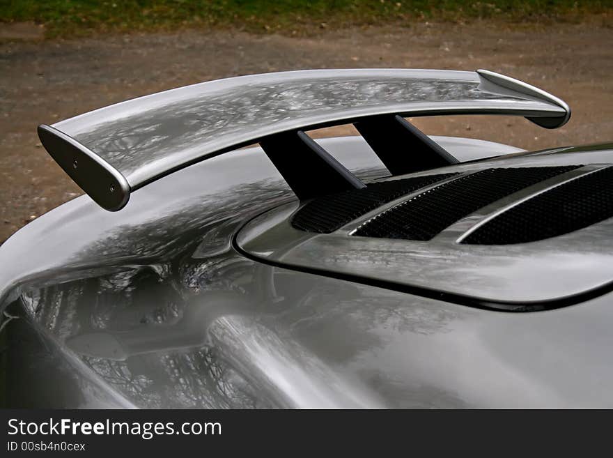 Rear spoiler on a grey english sportscar. Rear spoiler on a grey english sportscar