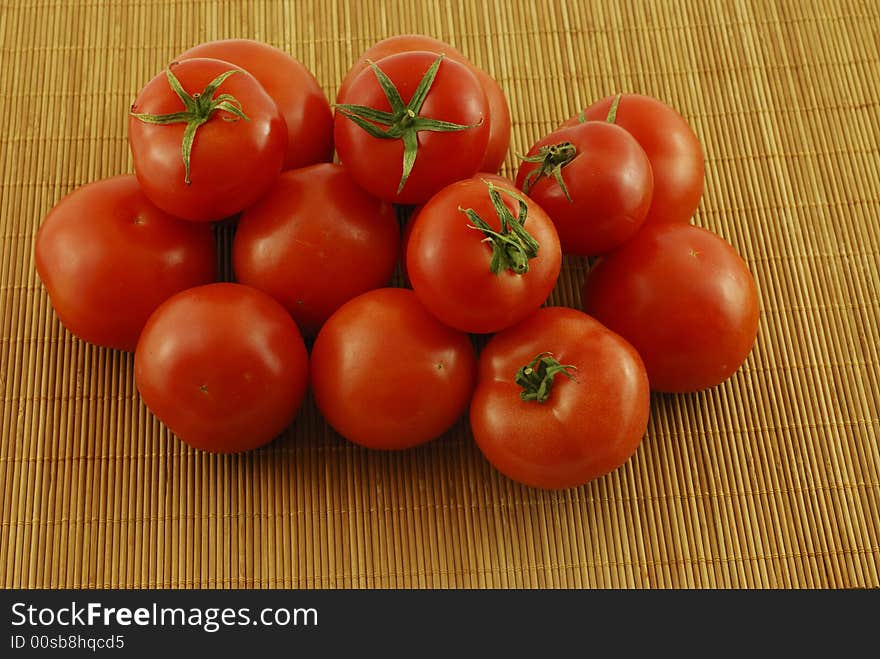 A fresh red tomatoes with a knife