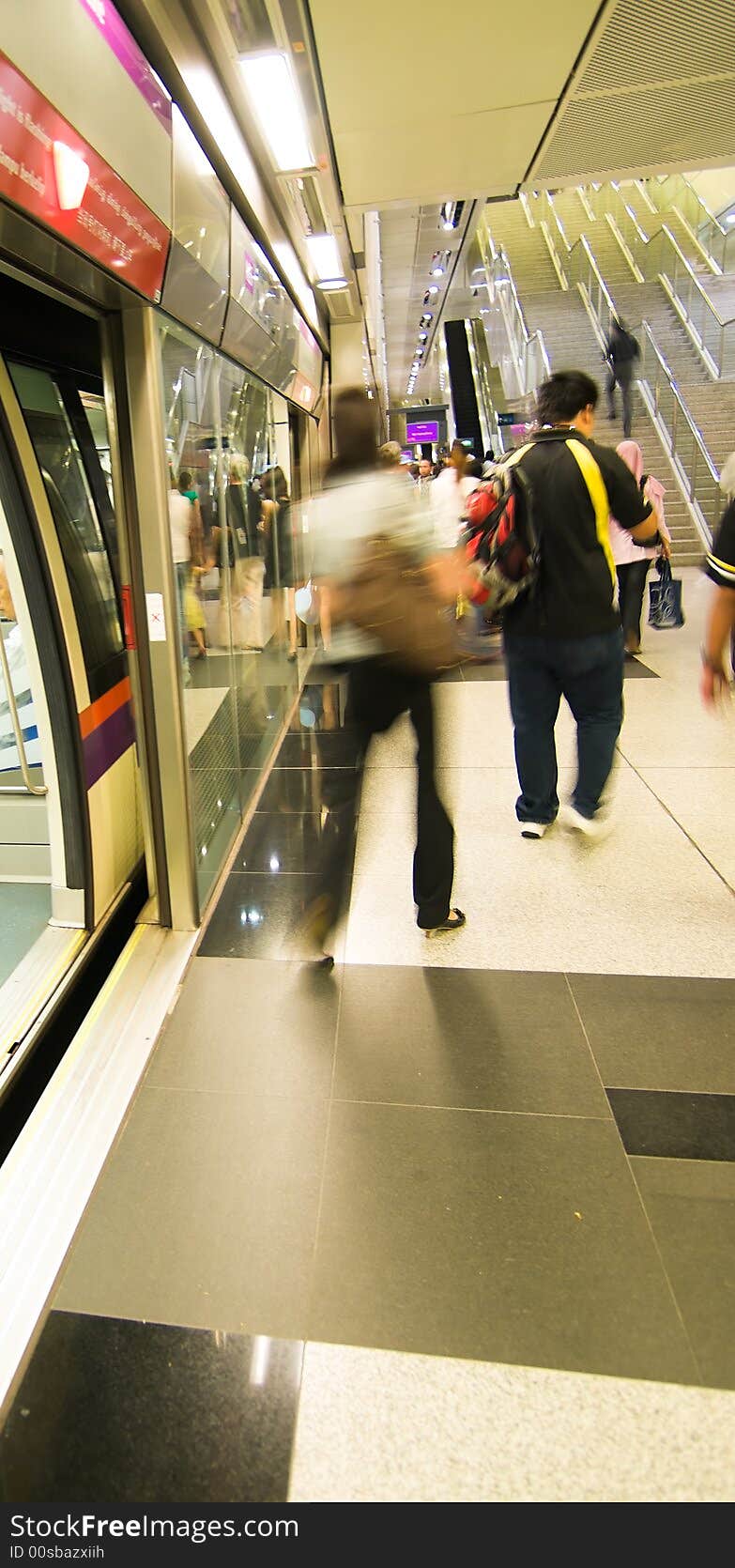 Passengers disembarking from a train in an underground station. Passengers disembarking from a train in an underground station