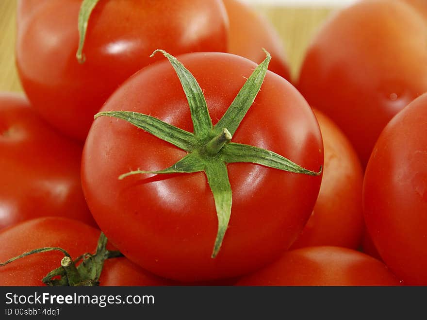 A fresh red tomatoes with a knife