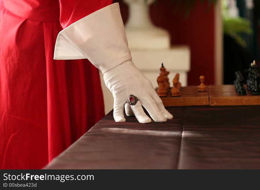 It's a riddle. Ren hand, white glove red gem and chess are from famous book. It's a riddle. Ren hand, white glove red gem and chess are from famous book.