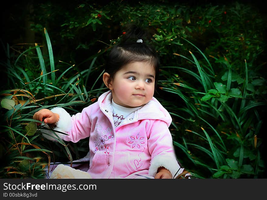 A six months old girl sitting in the tall grasses. A six months old girl sitting in the tall grasses