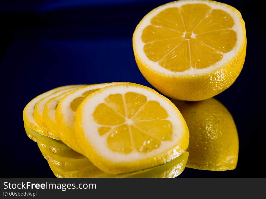 Lemon and Lime slices and halves against a dark background. Lemon and Lime slices and halves against a dark background