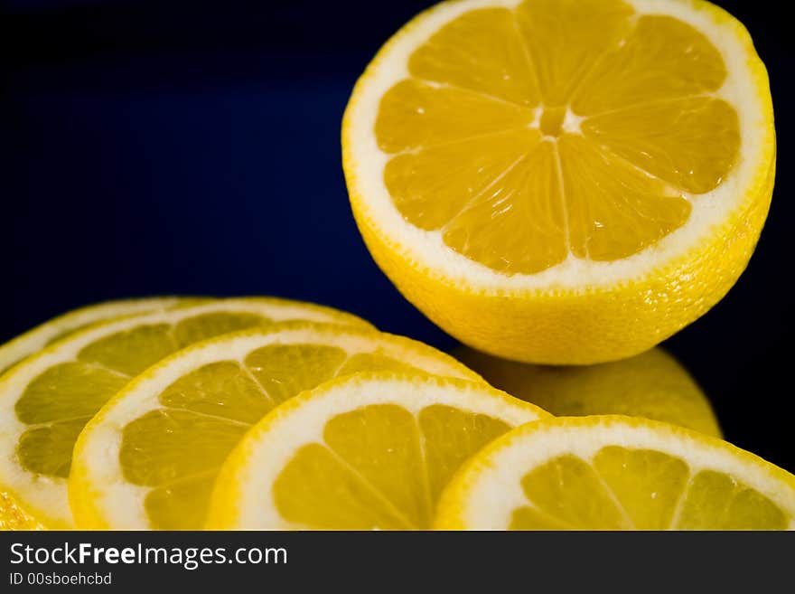 Lemon and Lime slices and halves against a dark background. Lemon and Lime slices and halves against a dark background