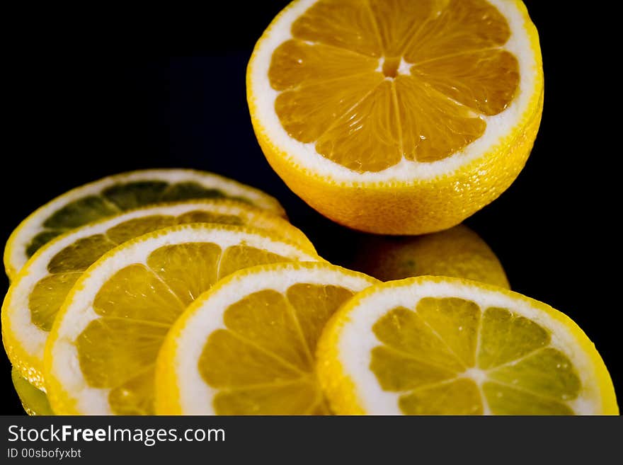 Lemon and Lime slices and halves against a dark background. Lemon and Lime slices and halves against a dark background