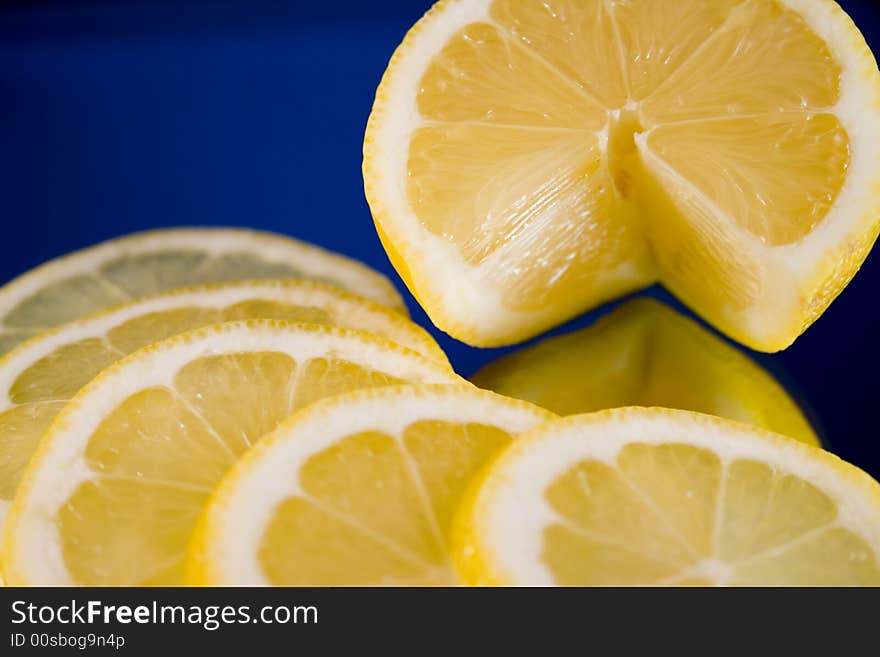 Lemon and Lime slices and halves against a dark background. Lemon and Lime slices and halves against a dark background