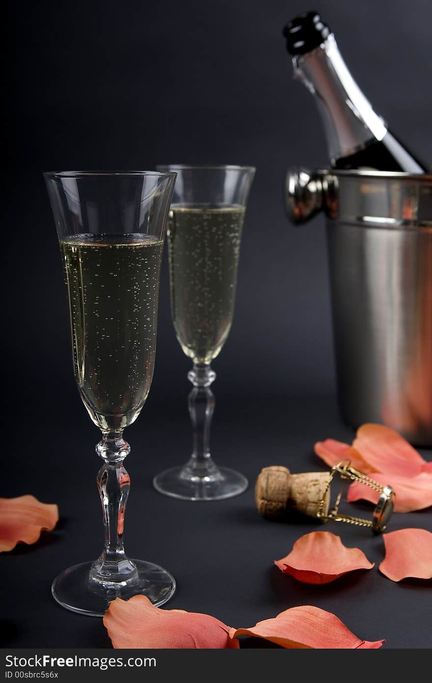 Champagne in a champagne bucket with a lot of ice keeping cold. Champagne in a champagne bucket with a lot of ice keeping cold