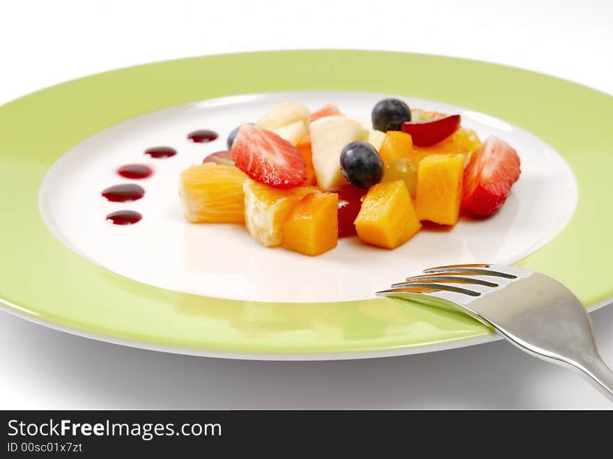 Fruit salad composition in front of a white background