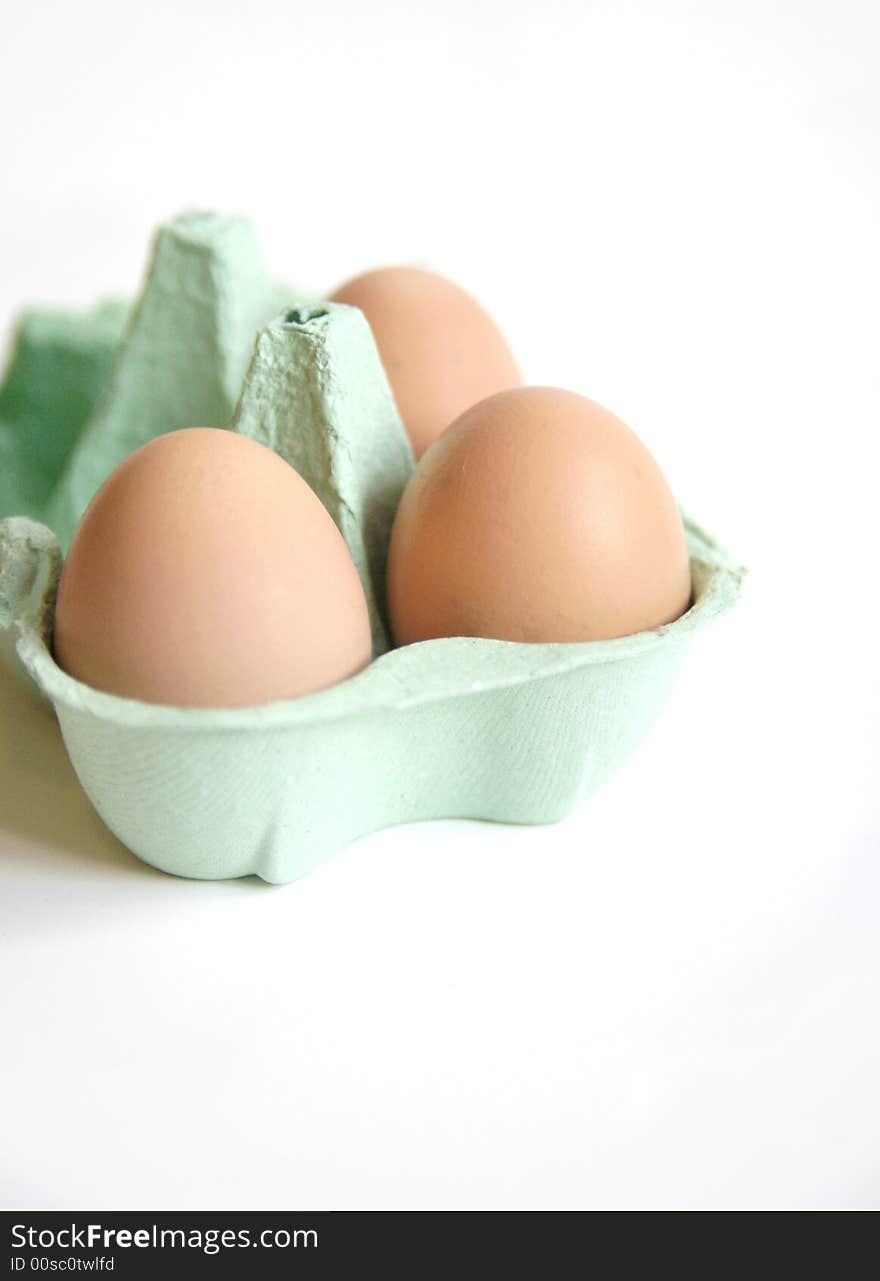 Fresh free range eggs in green egg box on white background. Fresh free range eggs in green egg box on white background