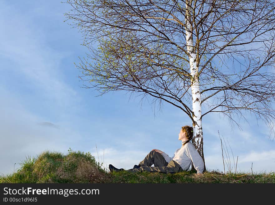 Woman under the birch at field