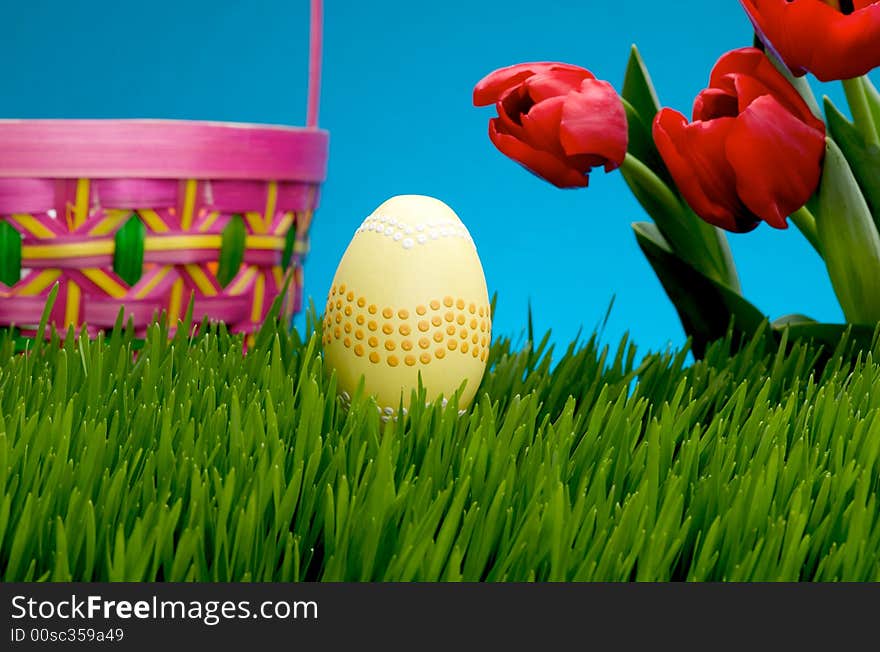 An image of a pastel easter egg in lush grass