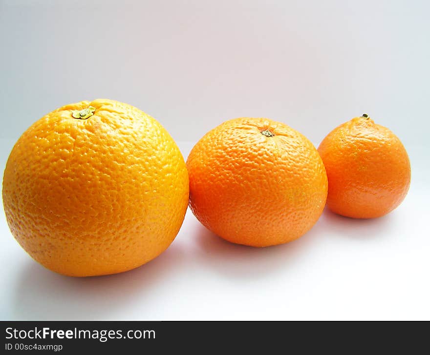 Oranges and tangerine on grey background