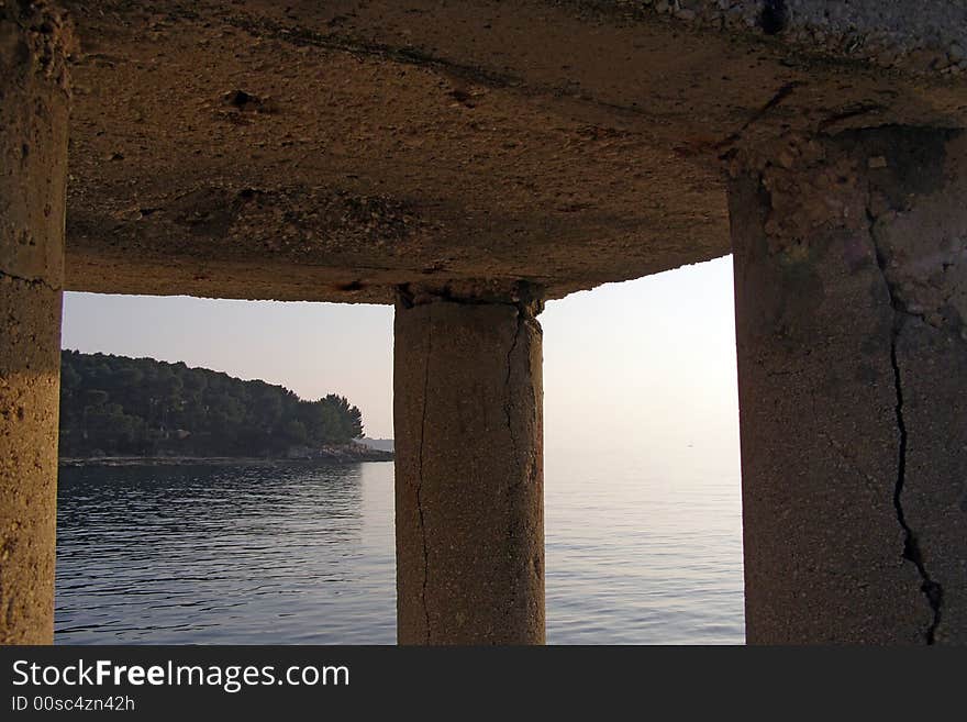 Peninsula view through pillars at sunset