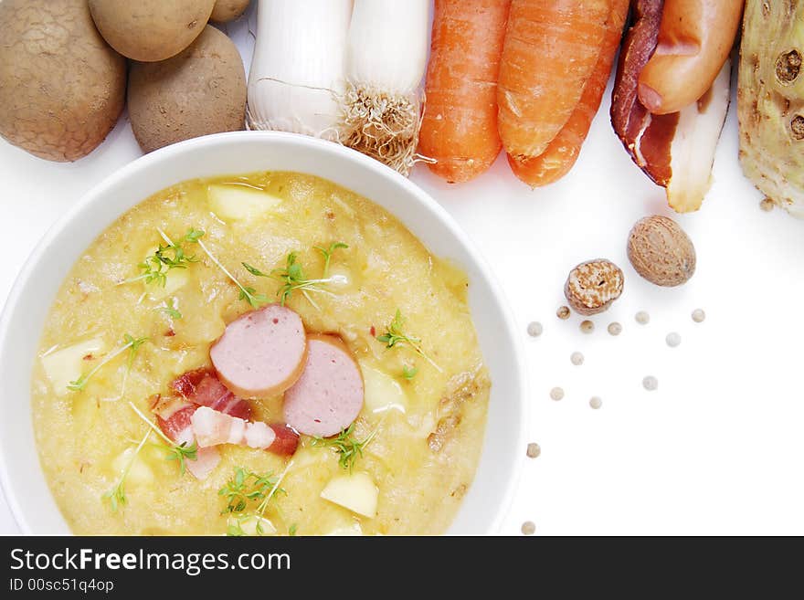 Fresh potatoe soup in a bowl arranged with fresh
vegetables. Fresh potatoe soup in a bowl arranged with fresh
vegetables