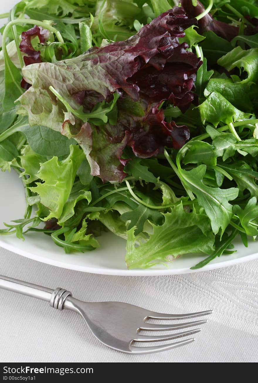 Fresh Leaf Salad With Fork On Tea-cloth