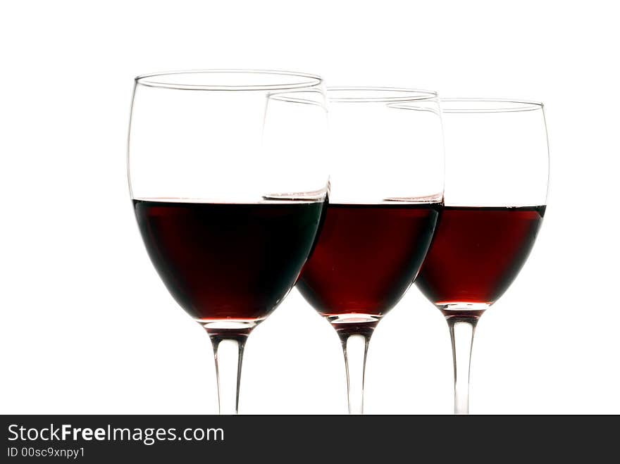 Three glasses of red wine isolated on a white background. Three glasses of red wine isolated on a white background