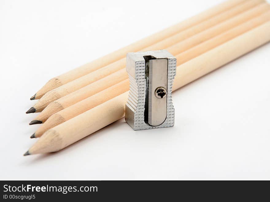 Pencils with pencil sharpener on white