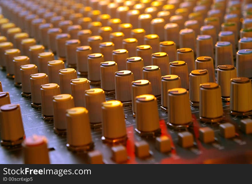 Soundboard mixer under multi-colored lights