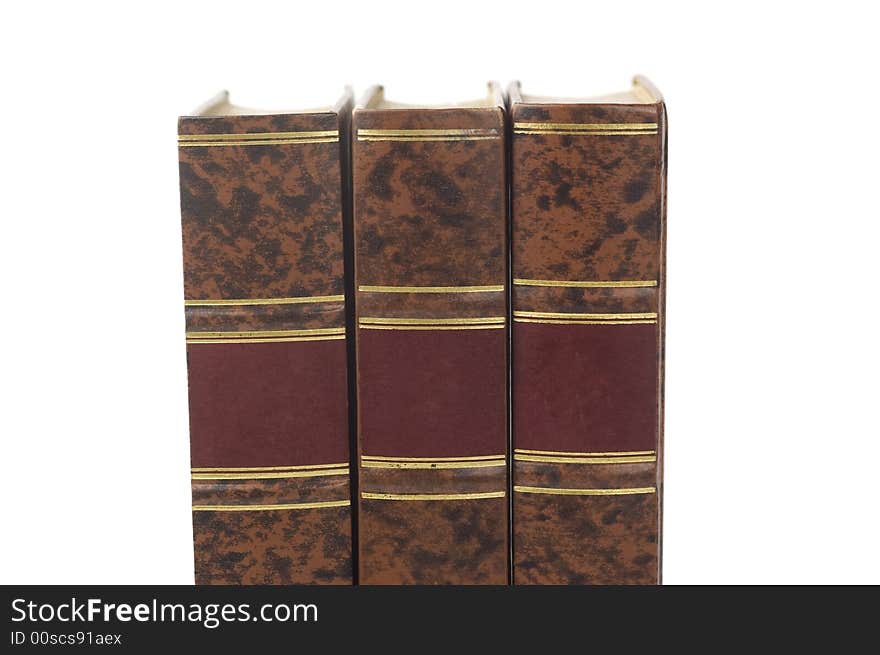 Row of three old books isolated on white background