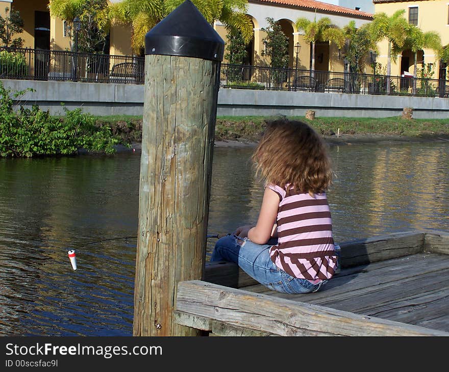 Little girl fishing from dock