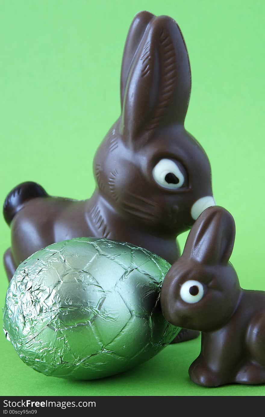 Chocolate easter bunnies with colorful wrapped egg