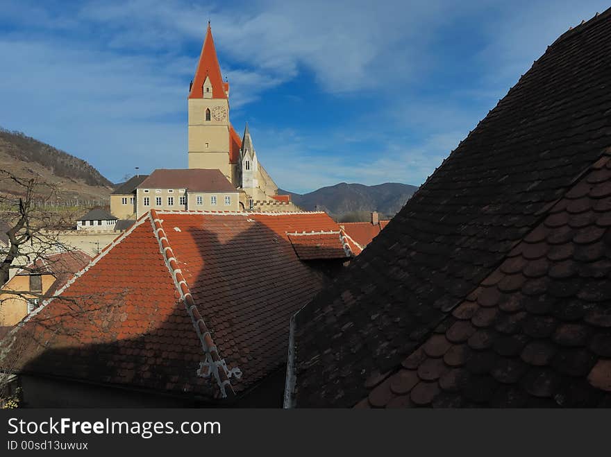 Historic church of Weissenkirchen with blue sky and clouds. Historic church of Weissenkirchen with blue sky and clouds