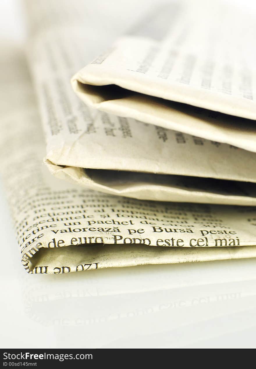 Stack of newspapers isolated on white