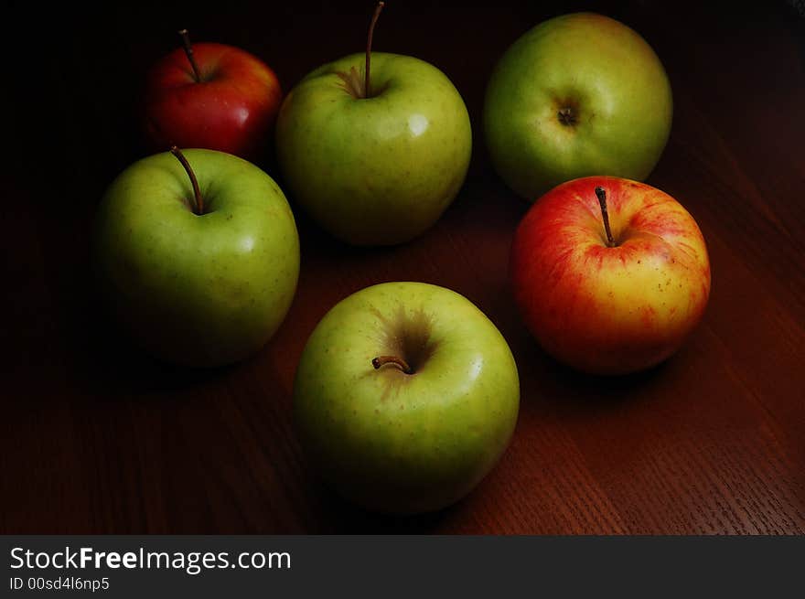 Group of colored apples on the dark background