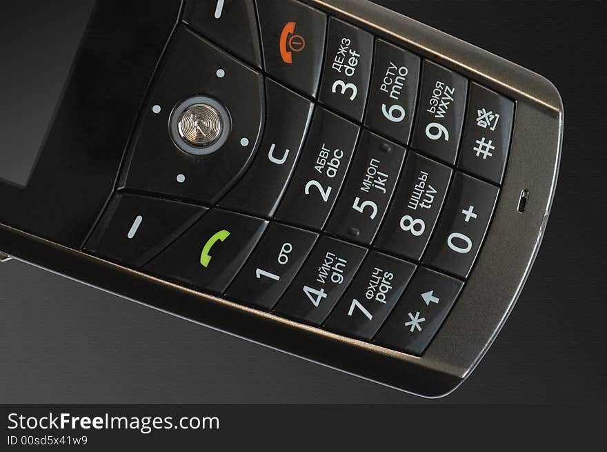 Keypad of mobile phone on the textured black background