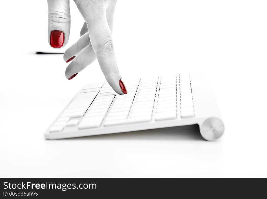 Fingers with red nail touching keyboard