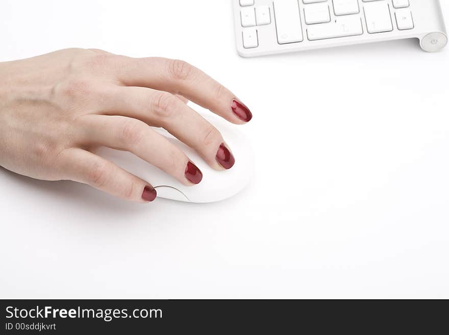 Fingers with red nail holding a mouse