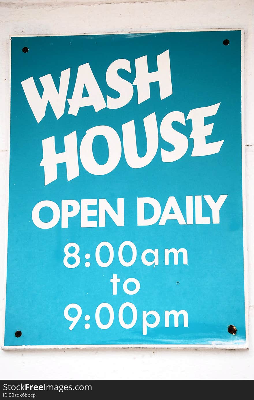 Wash house sign with hours posted. Wash house sign with hours posted.