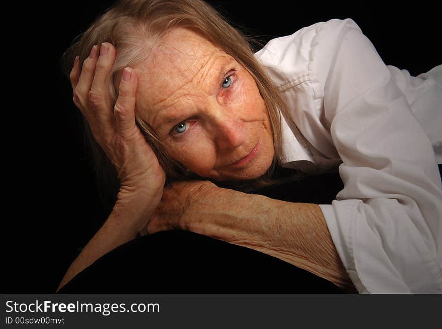 Image of a beautiful woman Reclining on Black. Image of a beautiful woman Reclining on Black