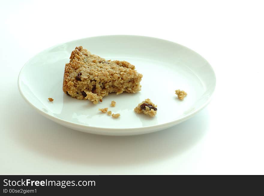 Flapjack oat bars on a white plate isolated on white. Flapjack oat bars on a white plate isolated on white