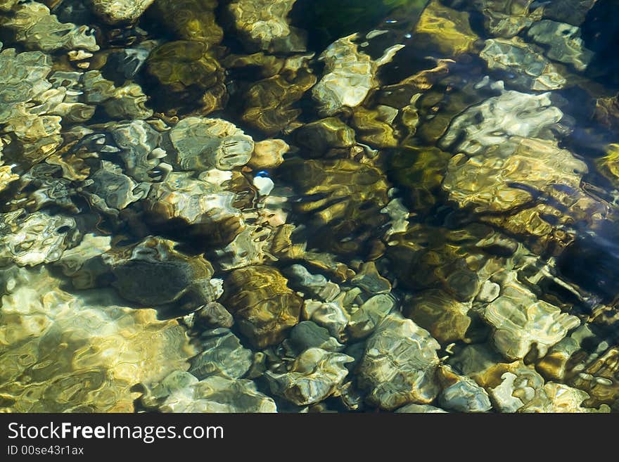 Sea stone illuminated by bright sunshines