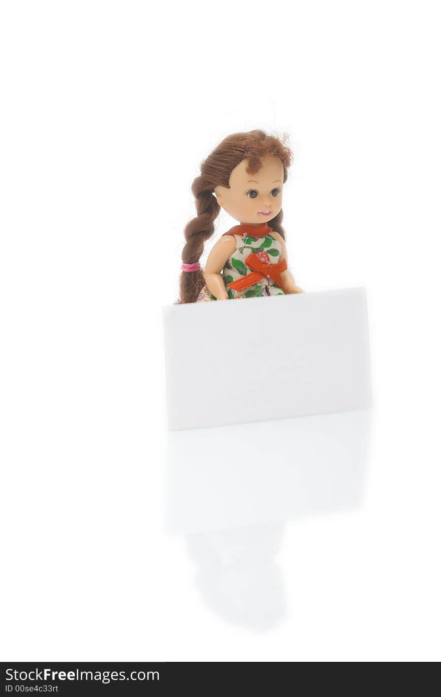 A little doll with white blank card isolated on white background. A little doll with white blank card isolated on white background