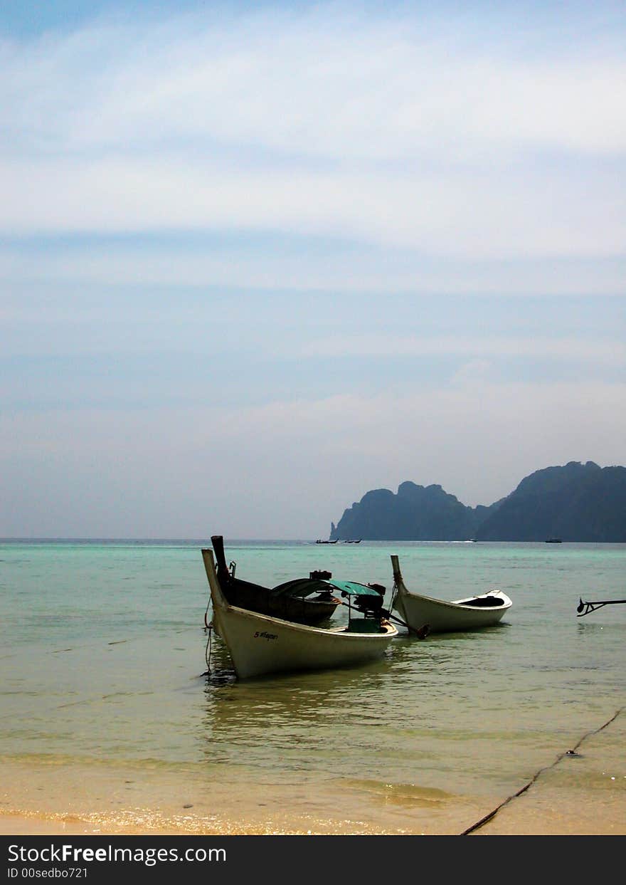 White boats parked at the beach of phiphi island